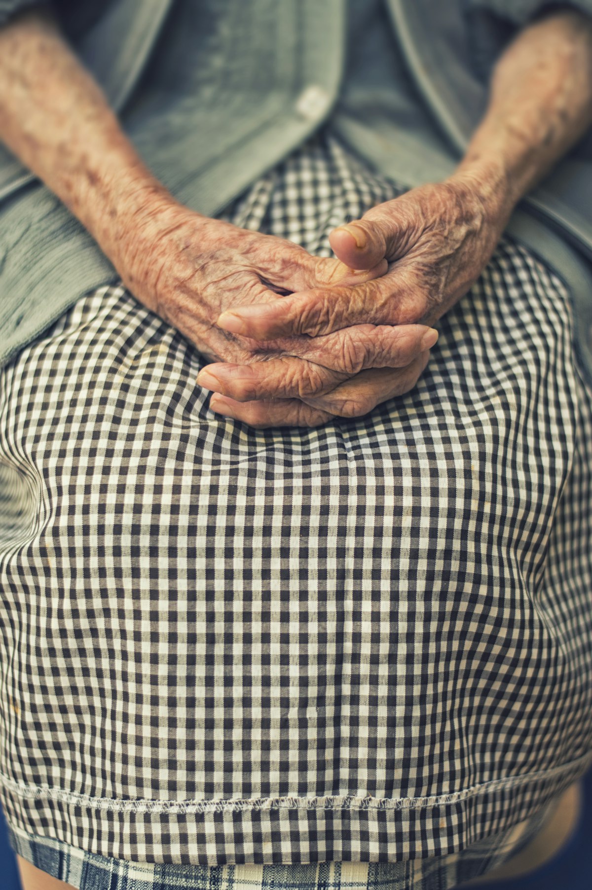 Close-up of an elderly client's hands, resting calmly