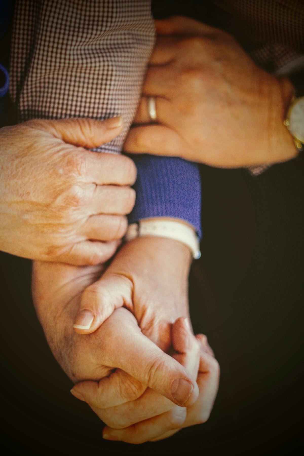 A carer holding the hands of an elderly client, a quiet moment of trust and reassurance