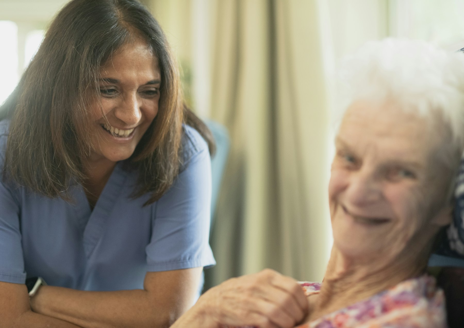 A BSMD Care carer sharing a warm moment with a client at home